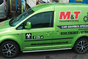 distance side view of our recondtitioned gearbox and differential metalic lime green sign written delivery van