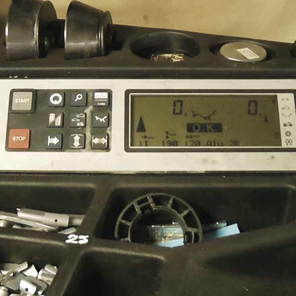 close up view of wheel balancing equipments digital lcd display showing where to add weights to balance the wheel on test